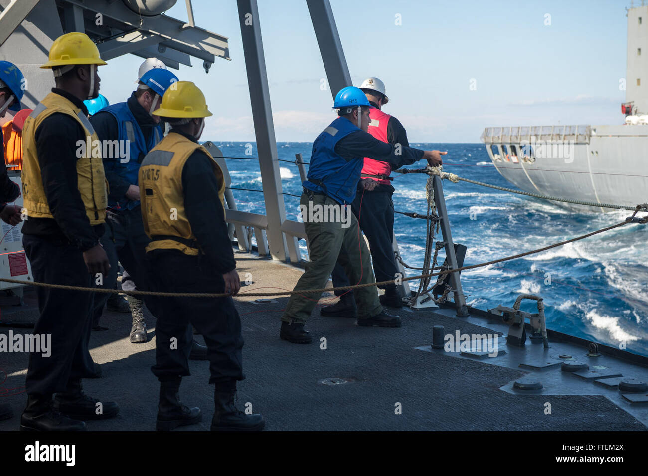 MEDITERRANEAN SEA (Feb. 20, 2015) Sailors aboard USS Donald Cook (DDG 75) rig up a connected-replenishment station during a replenishment-at-sea. Donald Cook, an Arleigh Burke-class guided-missile destroyer forward-deployed to Rota, Spain, is conducting naval operations in the U.S. 6th Fleet area of operations in support of U.S. national security interests in Europe. Stock Photo