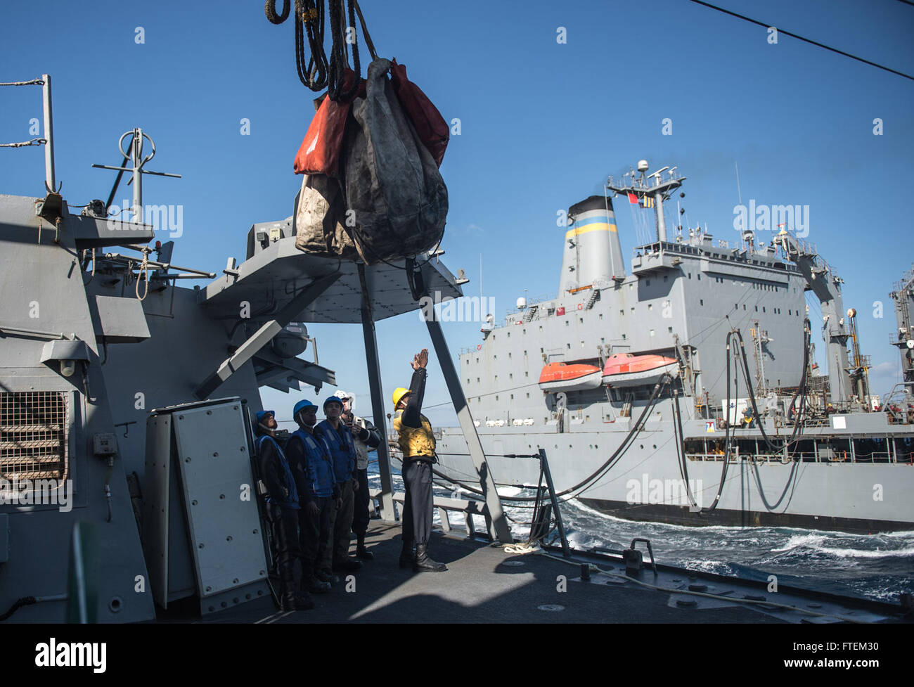 MEDITERRANEAN SEA (Feb. 20, 2015) Sailors aboard USS Donald Cook (DDG 75) participate in a replenishment-at-sea. Donald Cook, an Arleigh Burke-class guided-missile destroyer forward-deployed to Rota, Spain, is conducting naval operations in the U.S. 6th Fleet area of operations in support of U.S. national security interests in Europe. Stock Photo
