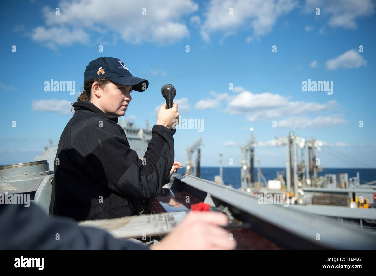 MEDITERRANEAN SEA (Feb. 20, 2015) Ens. Jillian Coughlin, from Annapolis, Maryland, serves as the conning officer during a replenishment-at-sea aboard USS Donald Cook (DDG 75). Donald Cook, an Arleigh Burke-class guided-missile destroyer forward-deployed to Rota, Spain, is conducting naval operations in the U.S. 6th Fleet area of operations in support of U.S. national security interests in Europe. Stock Photo