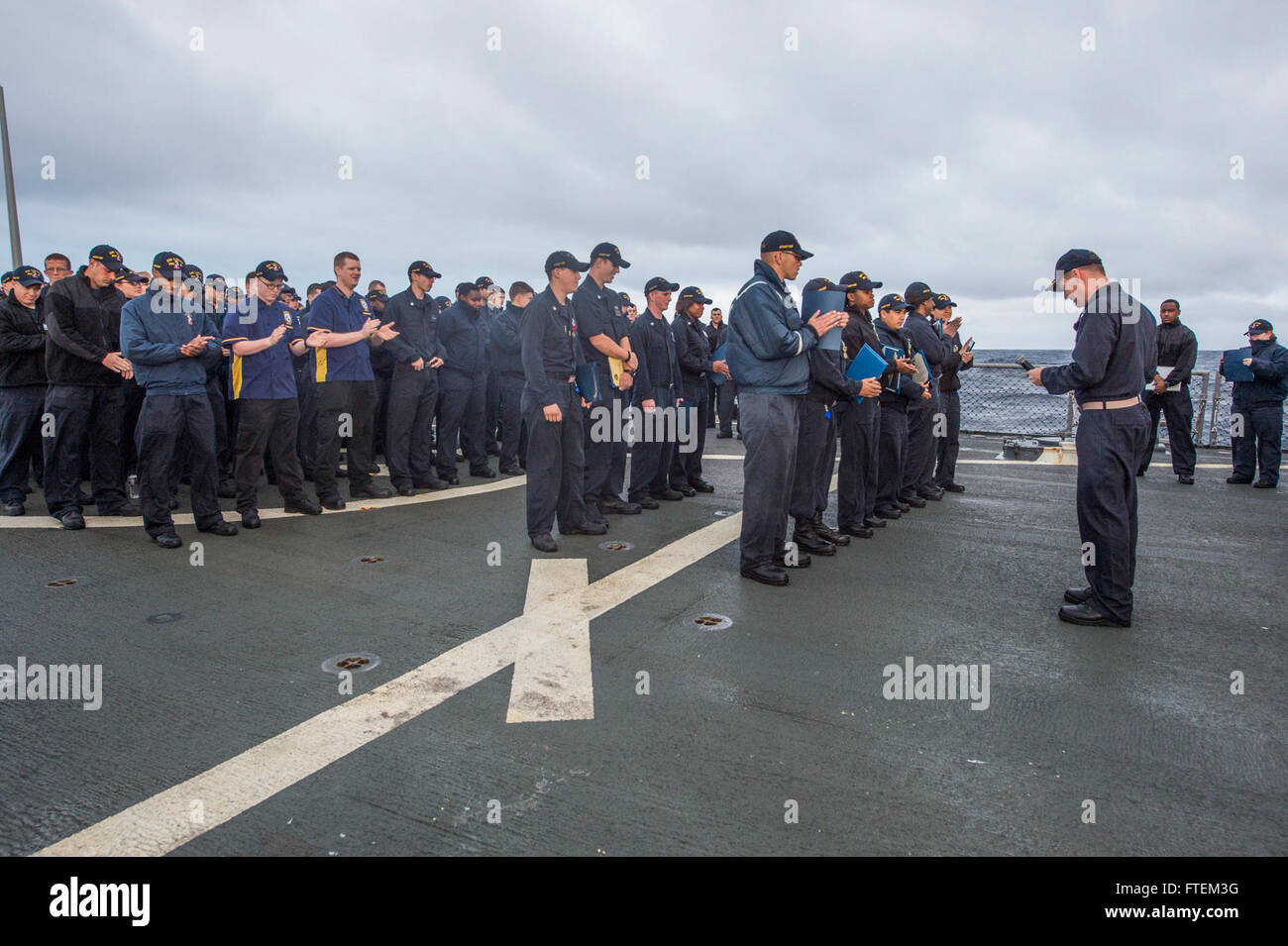 ATLANTIC OCEAN (Feb. 21, 2015) USS Laboon (DDG 58) Commanding Officer Cmdr. Christopher M. McCallum updates Sailors on upcoming operations during an all-hands call on the flight deck Feb. 21, 2015. Laboon, an Arleigh Burke-class guided-missile destroyer, homeported in Norfolk, is conducting naval operations in the U.S. 6th Fleet area of operations in support of U.S. national security interests in Europe. Stock Photo