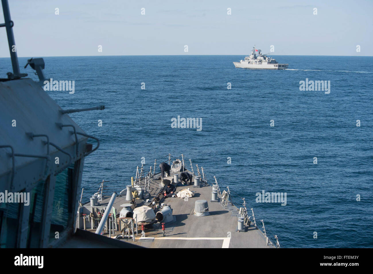 BLACK SEA (Feb. 21, 2015) - Turkish frigate Yildirim (F 234) conducts division tactics with USS Cole (DDG 67), Feb. 21, 2015. Cole, an Arleigh Burke-class guided-missile destroyer, homeported in Norfolk, is conducting naval operations in the U.S. 6th Fleet area of operations in support of U.S. national security interests in Europe. Stock Photo