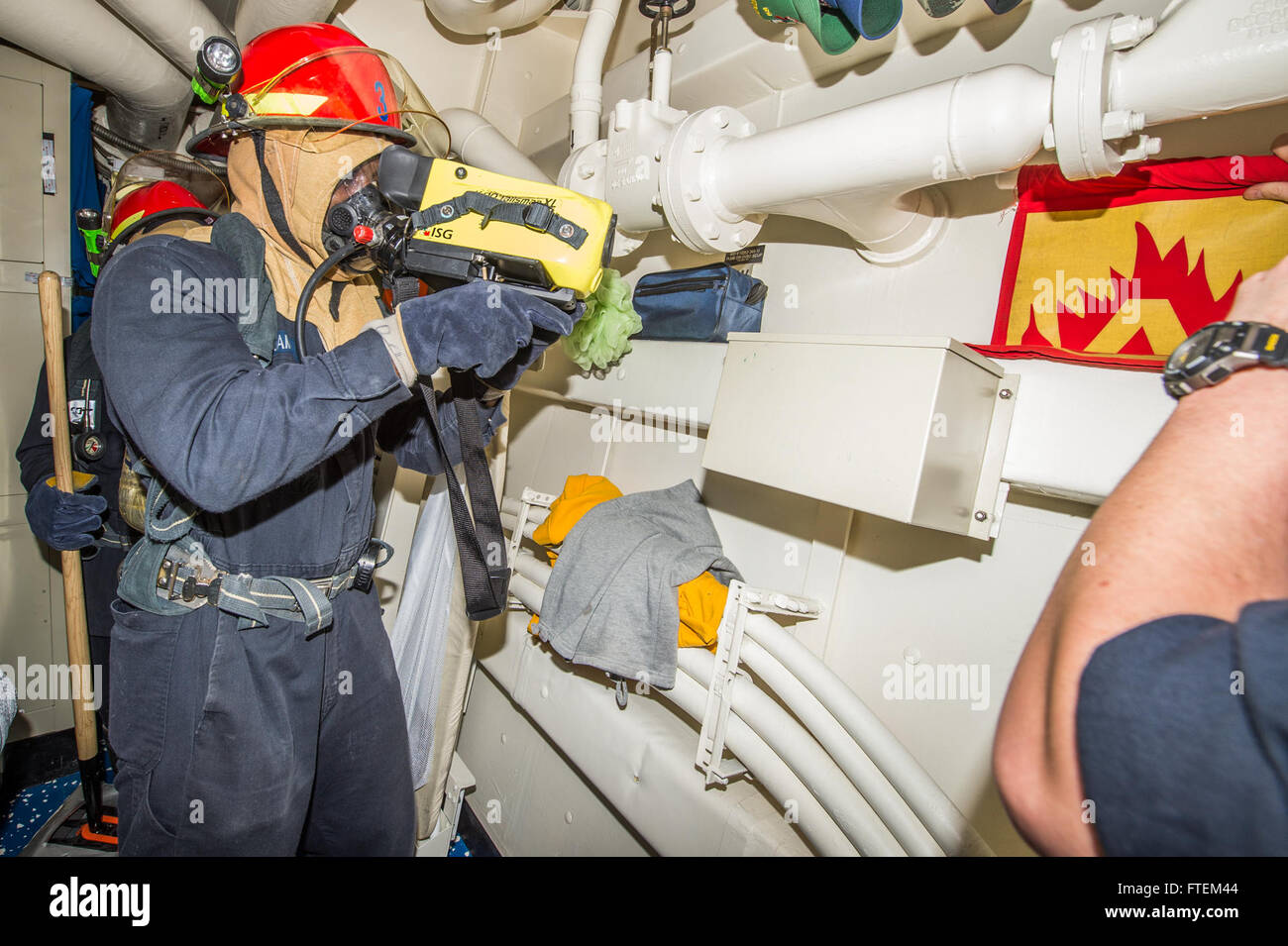 ATLANTIC OCEAN (Feb. 21, 2015) Damage Controlman Fireman Mark Williams, from Macon, Georgia, uses a Navy firefighter thermal imager during a fire drill aboard USS Laboon (DDG 58) Feb. 21, 2015. Laboon, an Arleigh Burke-class guided-missile destroyer, homeported in Norfolk, is conducting naval operations in the U.S. 6th Fleet area of operations in support of U.S. national security interests in Europe. Stock Photo