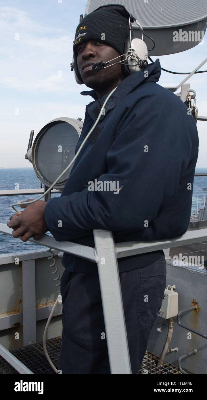 DARDANELLES  STRAIT (Feb. 22, 2015) - Culinary Specialist Samuel Ward, from Grants borough, North Carolina, stands lookout aboard USS Cole (DDG 67) as Cole transits the Dardanelles Strait, Feb. 22, 2015. Cole, an Arleigh Burke-class guided-missile destroyer, homeported in Norfolk, is conducting naval operations in the U.S. 6th Fleet area of operations in support of U.S. national security interests in Europe. Stock Photo