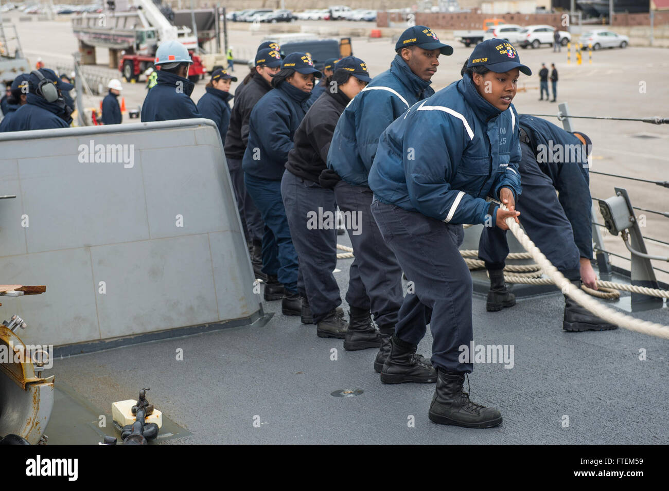 Spain (Feb. 23, 2015) Sailors aboard USS Laboon (DDG 58) heave around a mooring line while the ship moors atNaval Station Rota, Spain, Feb. 23, 2015. Laboon, an Arleigh Burke-class guided-missile destroyer, homeported in Norfolk, is conducting naval operations in the U.S. 6th Fleet area of operations in support of U.S. national security interests in Europe. Stock Photo