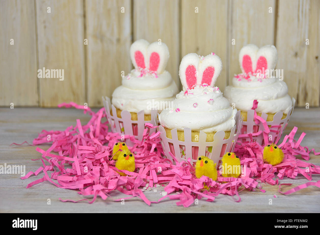 Marshmallow bunny ears in Easter cupcake icing with yellow chicks in