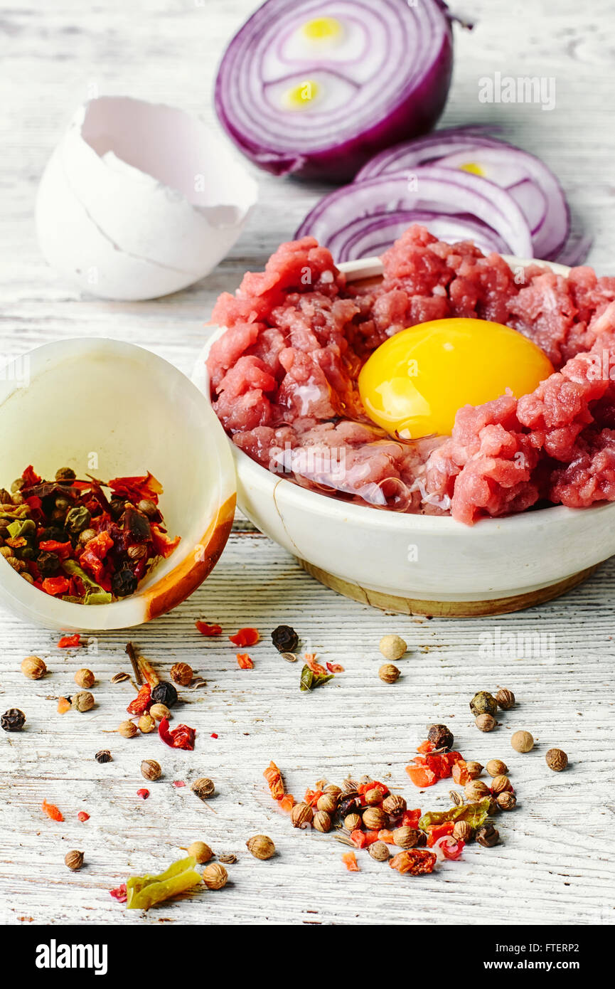 dish with raw minced beef with egg yolk and spice Stock Photo ...