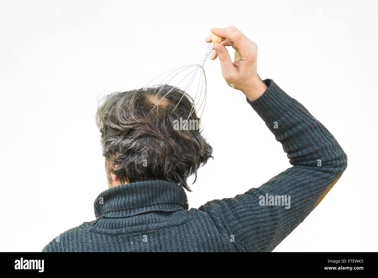 Man relaxes with the Genie head massager. Alternative Therapy. Indian
