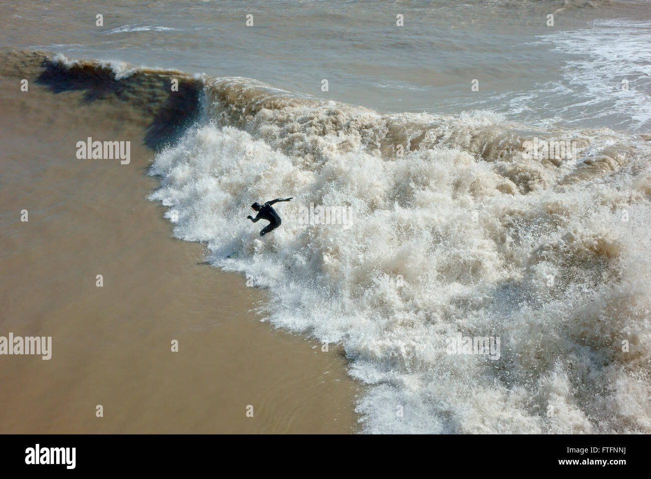 Hastings, East Sussex, 28th March 2016. Surfs up at Hastings in the