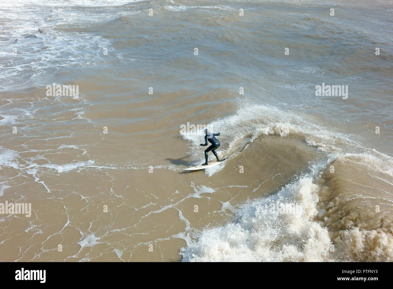 Hastings, East Sussex, 28th March 2016. Surfs up at Hastings in the
