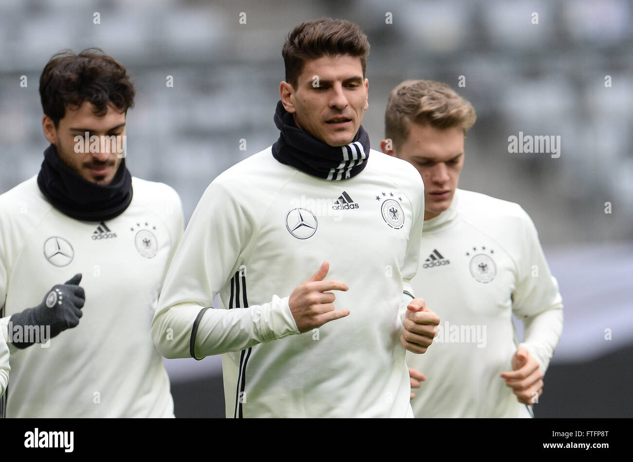 Mats Hummels (l-r), Mario Gomez and Matthias Ginter of the German national soccer team during the final practice at the Allianz Arena in Munich, Germany, 28 March 2016. Germany meets Italy in a try-out match on 29 March 2016. PHOTO: ANDREAS GEBERT/dpa Stock Photo