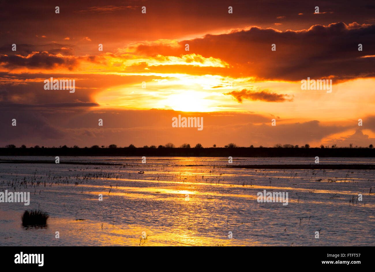 Sunset, Marshside, Southport, Merseyside, UK. 28th March 2016.  After strong blustery winds & heavy downpours, 'Storm Katie' fades away leaving a beautiful sunset over Southport's marshland.  Credit:  Cernan Elias/Alamy Live News Stock Photo