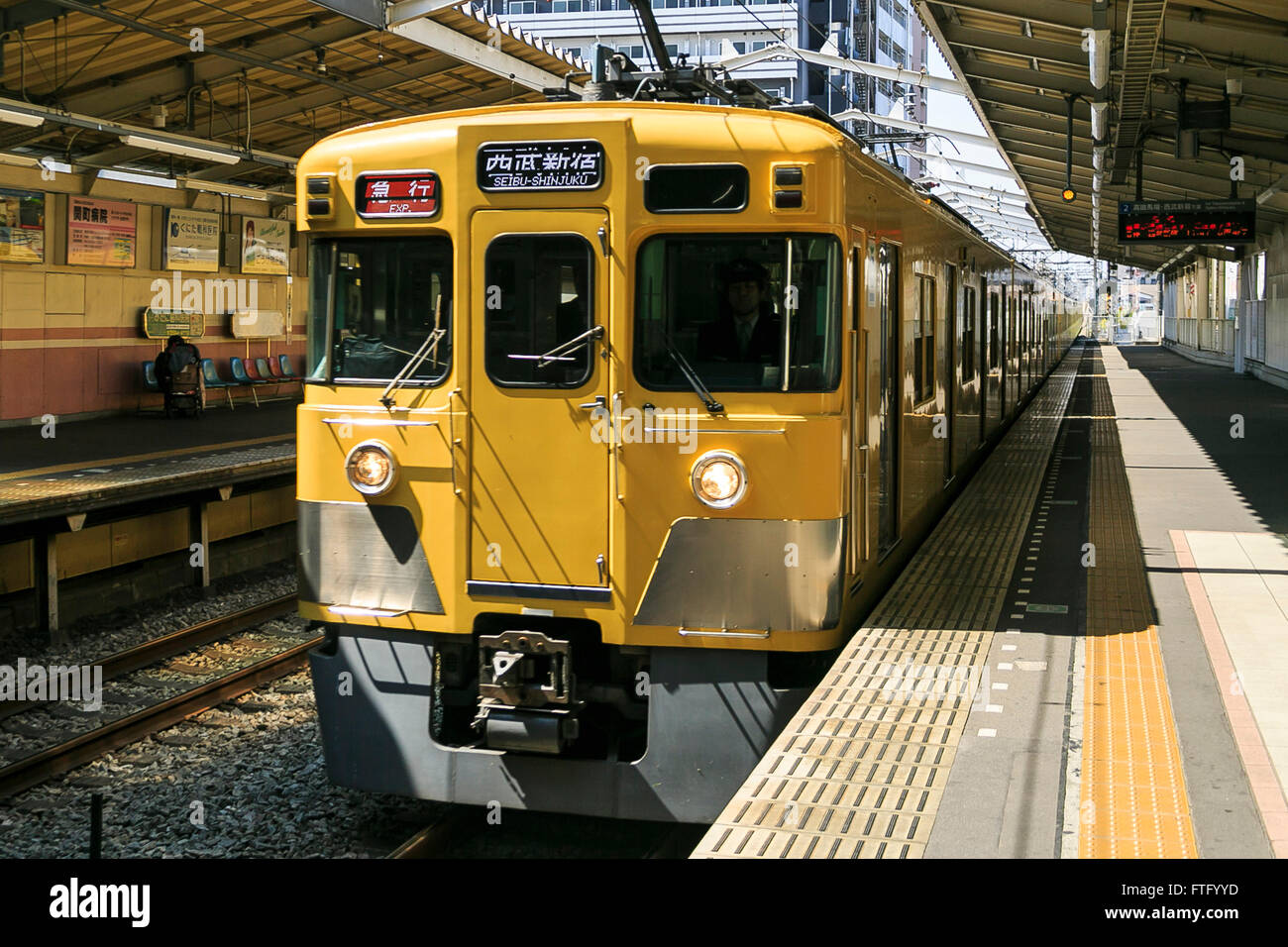 A yellow Seibu train arrives at Musashi-Seki station on March 29, 2016, Tokyo, Japan. Seibu Railway corporation announced that they will rent out entire carriages for party groups, on its Seibu Shinjuku, Ikebukuro, Hajima and Kokubunji Lines, allowing the group to choose which station to be picked up at and to be dropped off at. The special party service is aimed at alumni groups especially those that previously studied and commuted along one of the lines. In collaboration with Syoya Inc., a company specialised in organising alumni parties, the train company is taking bookings through till May Stock Photo