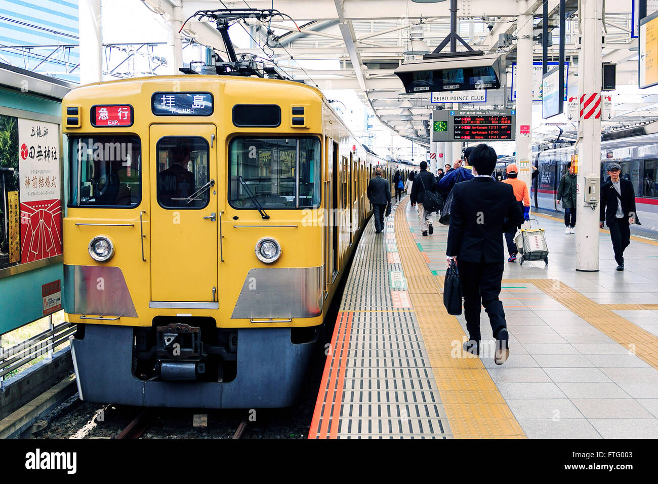 A yellow Seibu train arrives at Seibu-Shinjuku station on March 29, 2016, Tokyo, Japan. Seibu Railway corporation announced that they will rent out entire carriages for party groups, on its Seibu Shinjuku, Ikebukuro, Hajima and Kokubunji Lines, allowing the group to choose which station to be picked up at and to be dropped off at. The special party service is aimed at alumni groups especially those that previously studied and commuted along one of the lines. In collaboration with Syoya Inc., a company specialised in organising alumni parties, the train company is taking bookings through till M Stock Photo