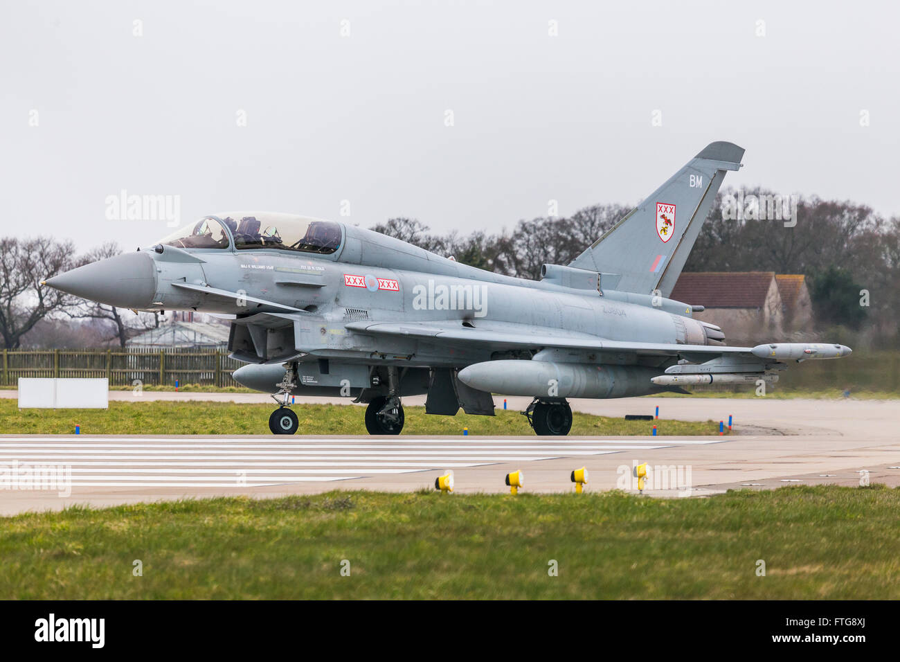 An RAF Typhoon enters the runway at RAF Coningsby. Stock Photo