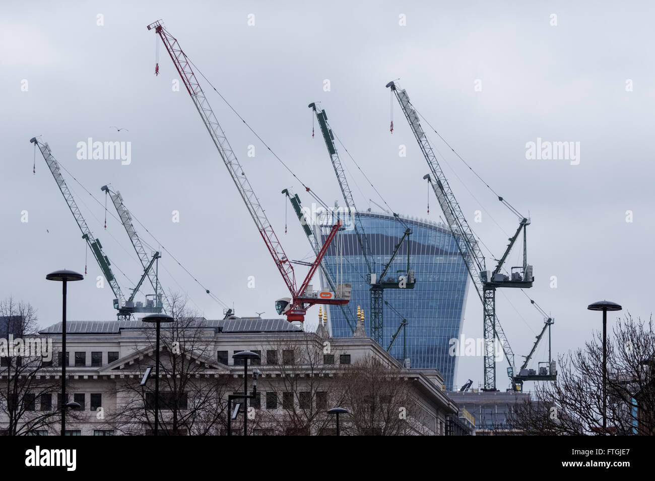 Cranes at construction site in the city with 20 Fenchurch Street building in the background, London England United Kingdom UK Stock Photo