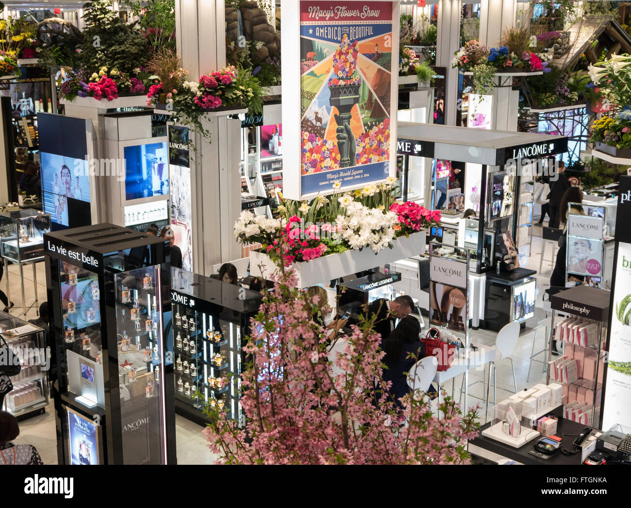 Macy's annual Flower Show: Looking down to the interior of store's cosmetics department decorated with flowers and plants Stock Photo