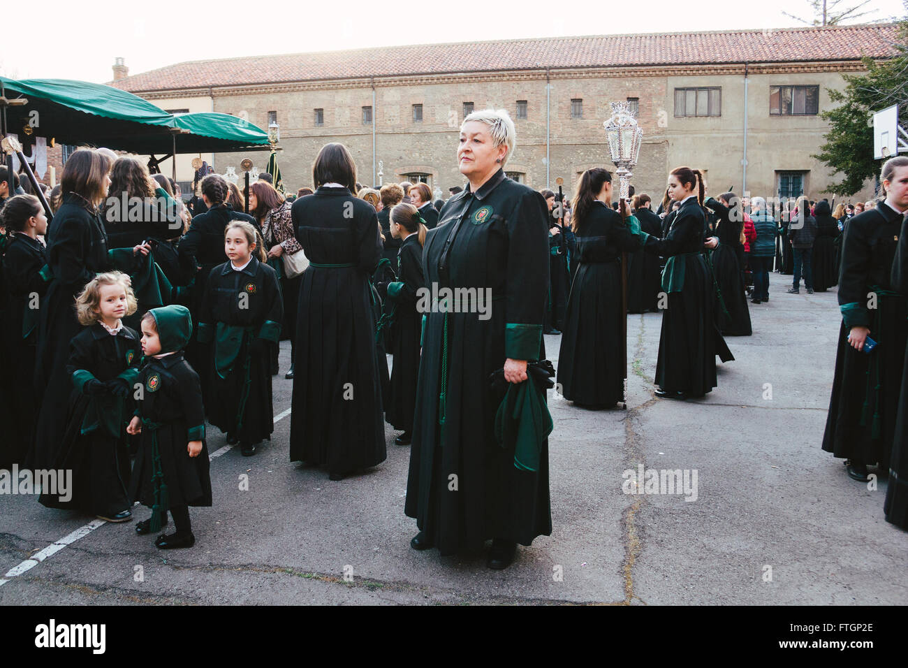 Female sisterhood during Holy Week in Spain. Woman standing in the middle in a mixed aged group. Stock Photo