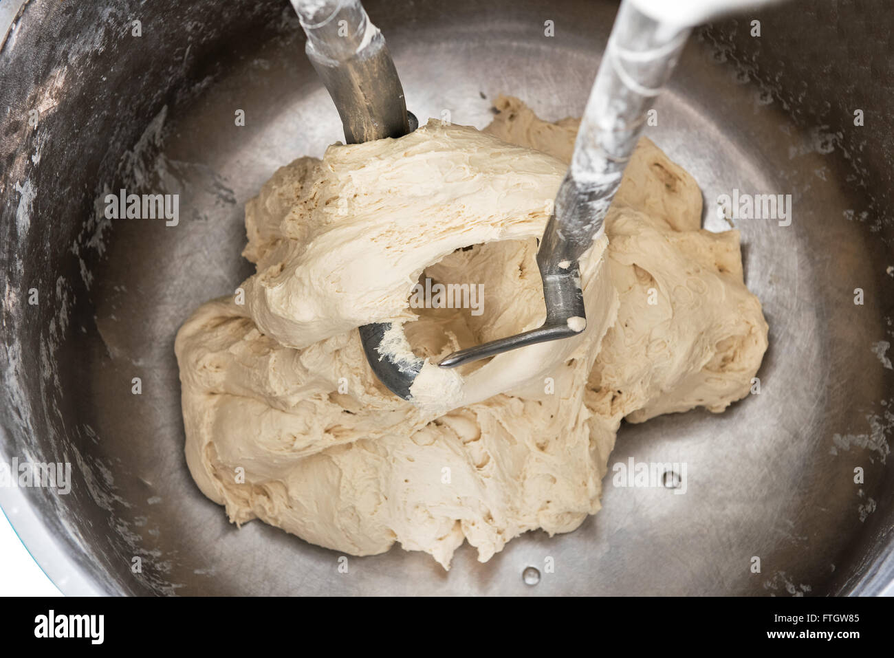 High Angle Close Up View of Dough Mixing in Industrial Mixer with Dough