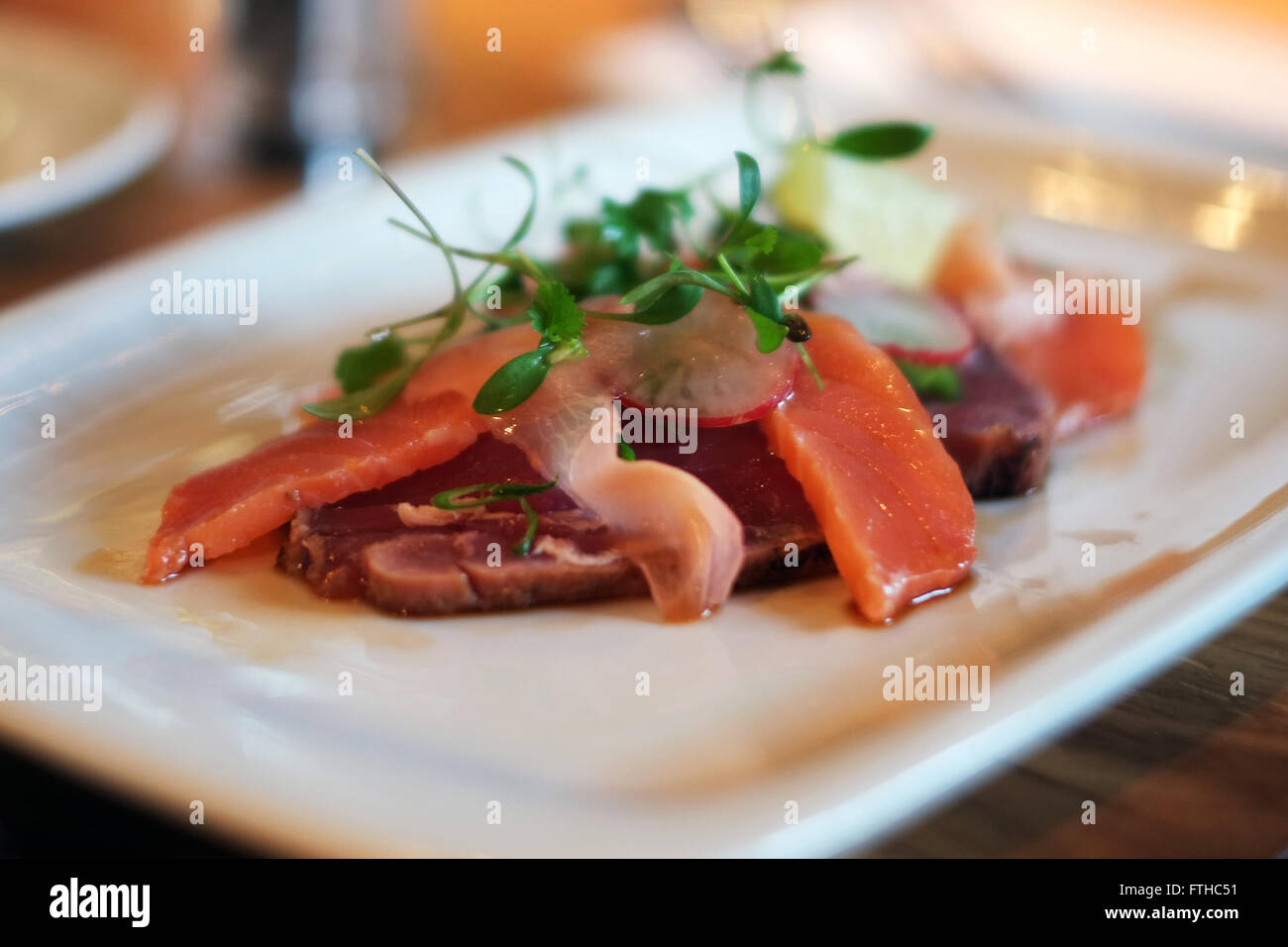 Close up view of seared tuna and salmon, in an english restaurant setting. Stock Photo