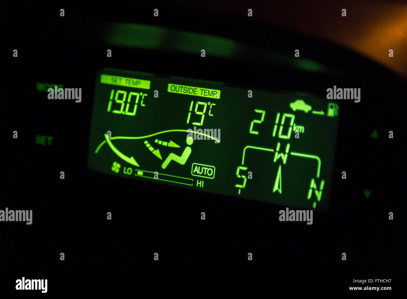 green highlighted car air conditioner control panel at night Stock