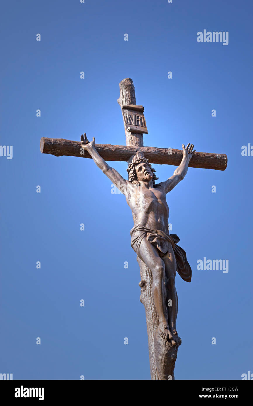 Statue of Jesus Christ on a cross. Blue sky in the background Stock ...