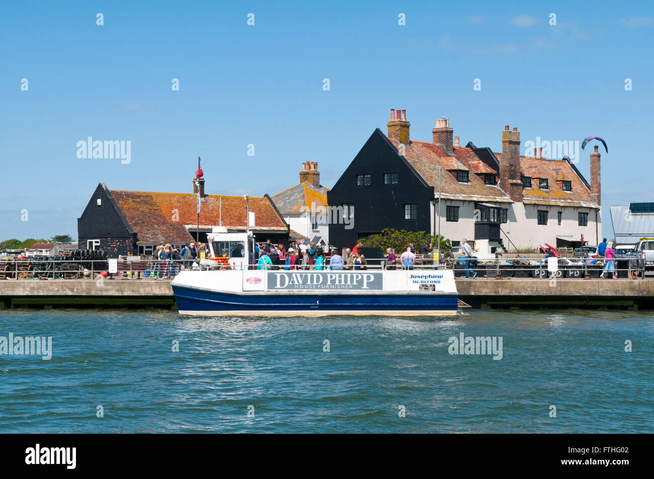 Mudeford Quay near Christchurch in Dorset with the ferry which takes tourists across the harbour mouth to Mudeford Sandbank Stock Photo