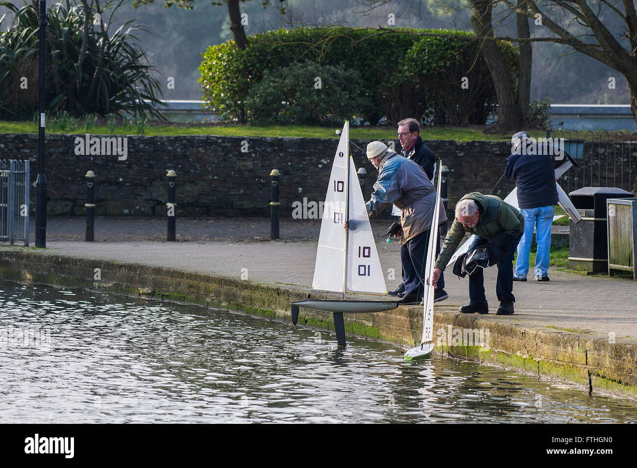 Members of the Newquay Model yacht Club prepare to launch their sail boats on Trenance Lake in Newquay, Cornwall. Stock Photo