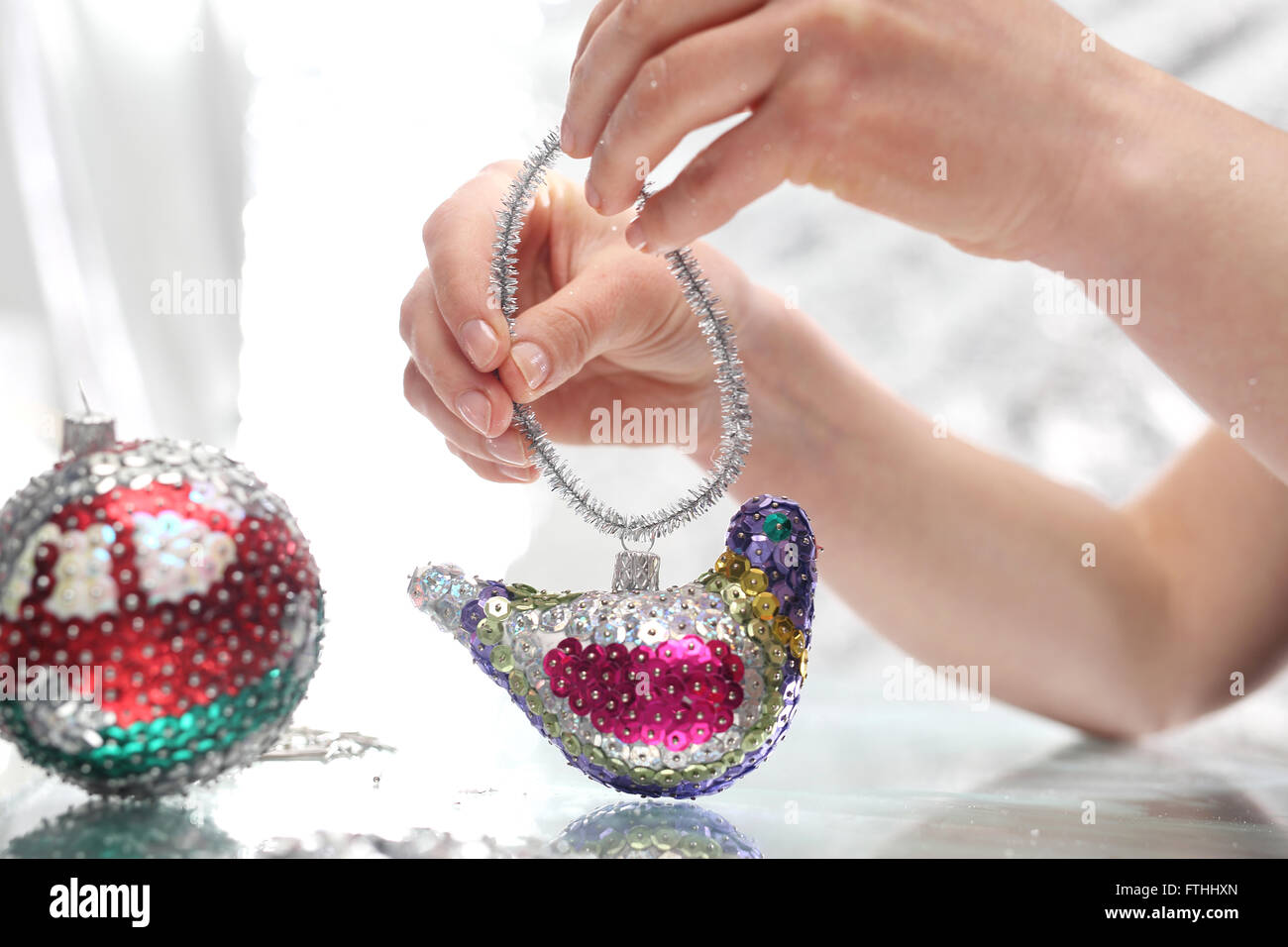 Sequined Christmas ornaments. The idea for a Christmas present, handmade sequin decoration. Sequin bauble Stock Photo