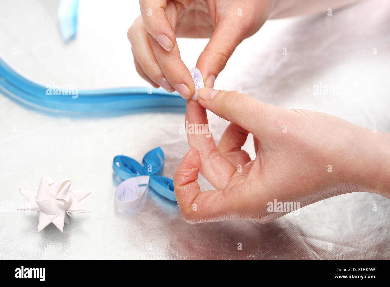 Hands women consisting of paper Christmas decorations, Origami paper star Stock Photo