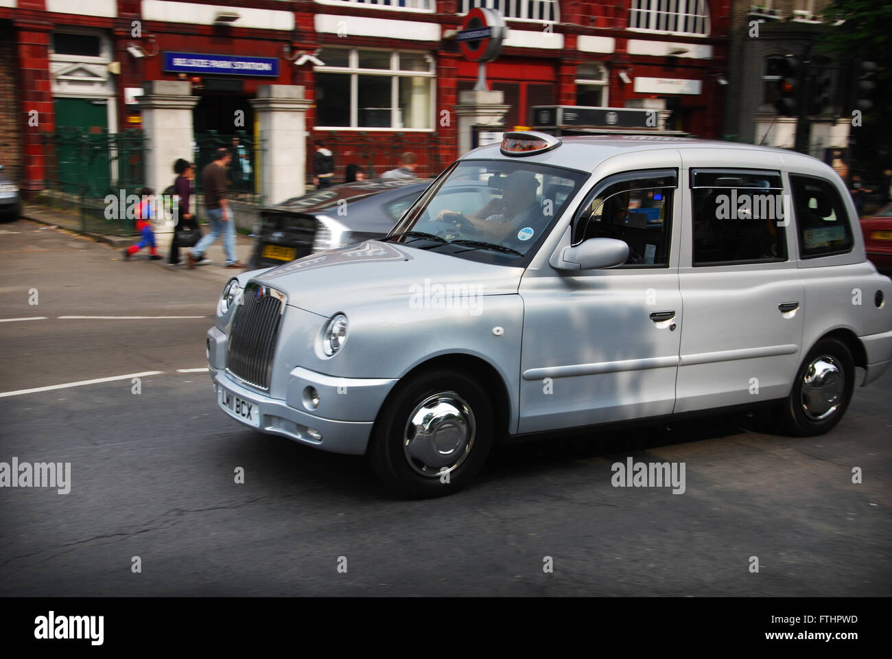 taxi passing Belsize Park Station, Hampstead London United Kingdom Stock Photo