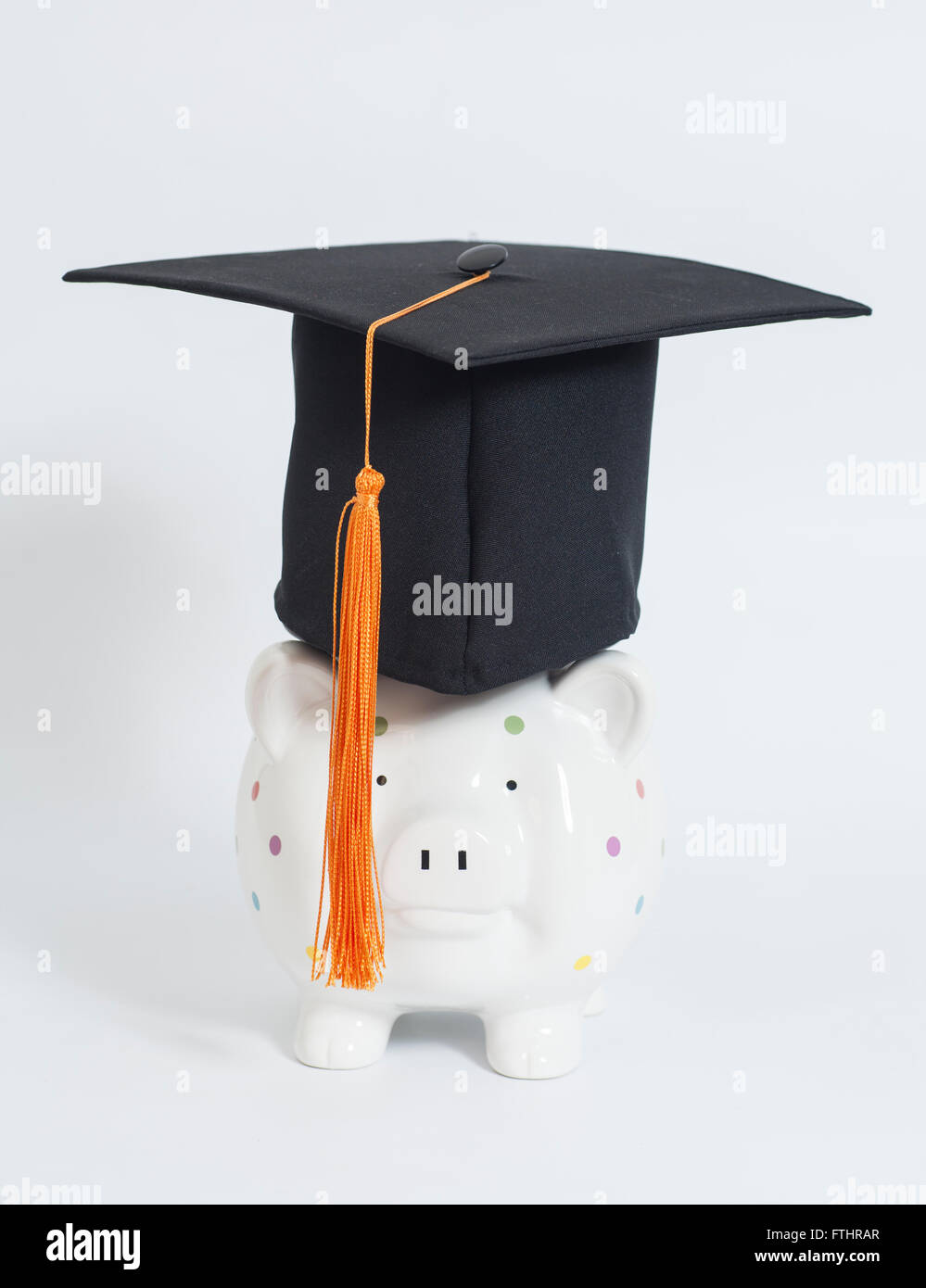 Piggy bank with black graduation hat on white background Stock Photo ...