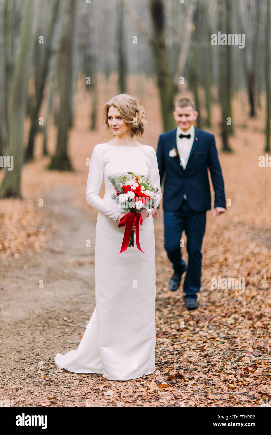 Happy stylish young bride and groom walking in the autumn forest Stock ...