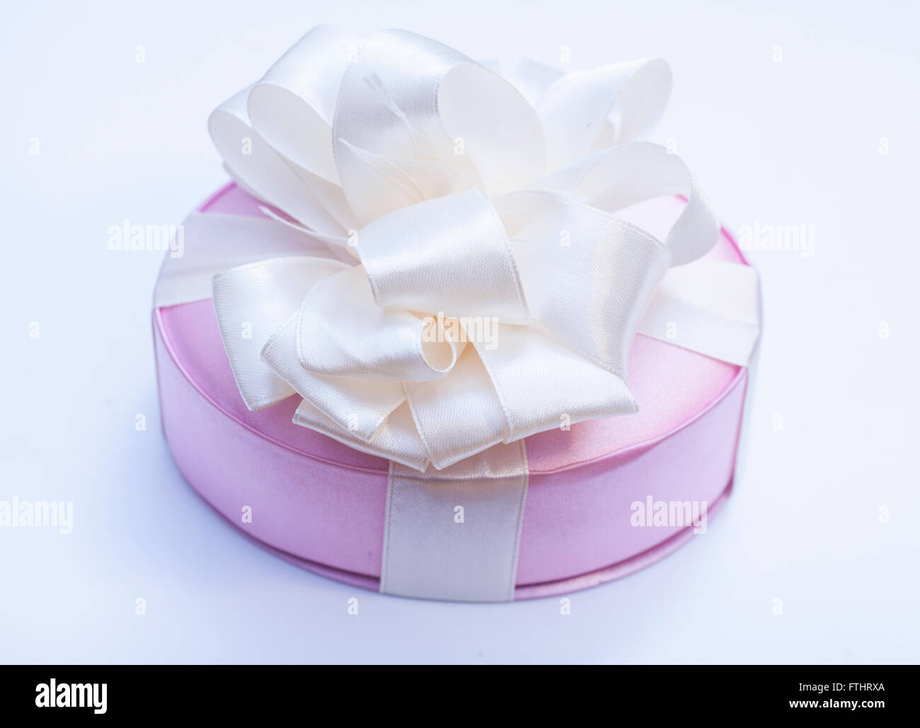 Gift box with ribbon bow on white background Stock Photo - Alamy