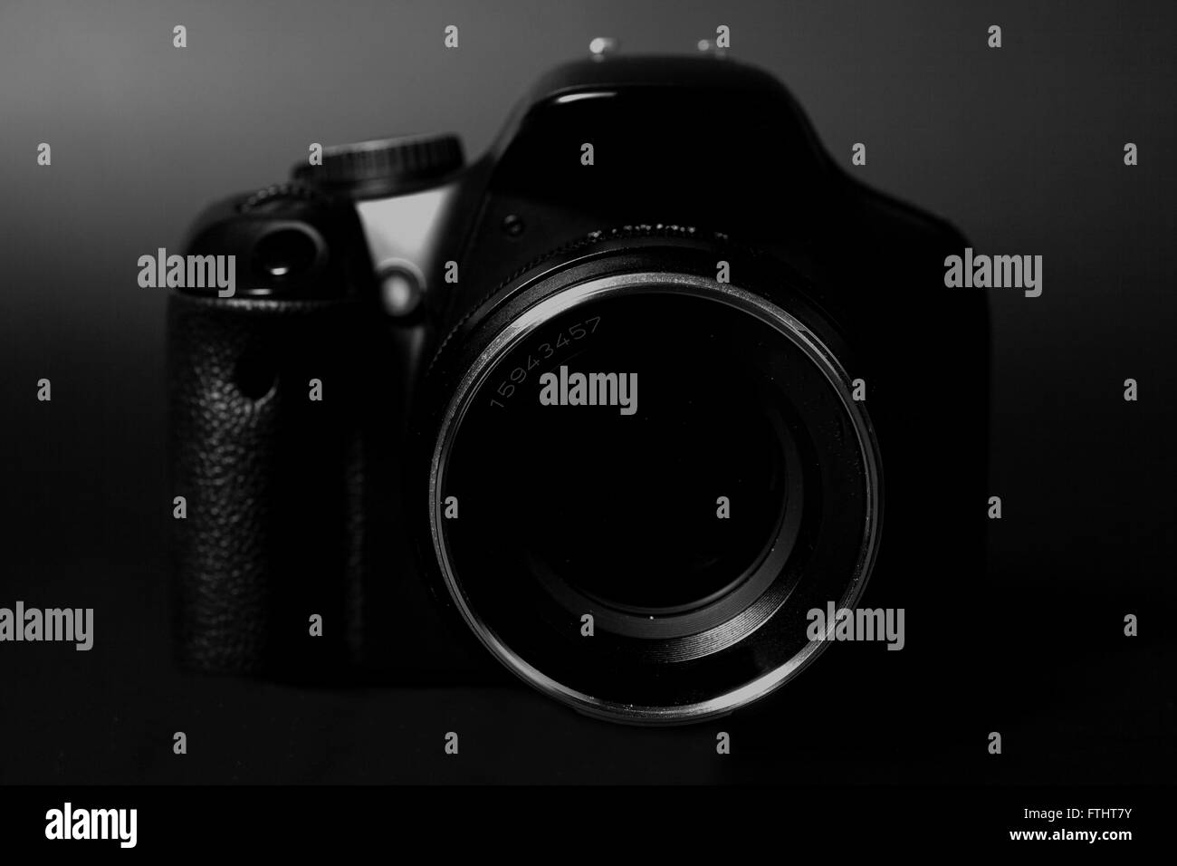 Professional modern DSLR camera with  aperture lens isolated on black Stock Photo