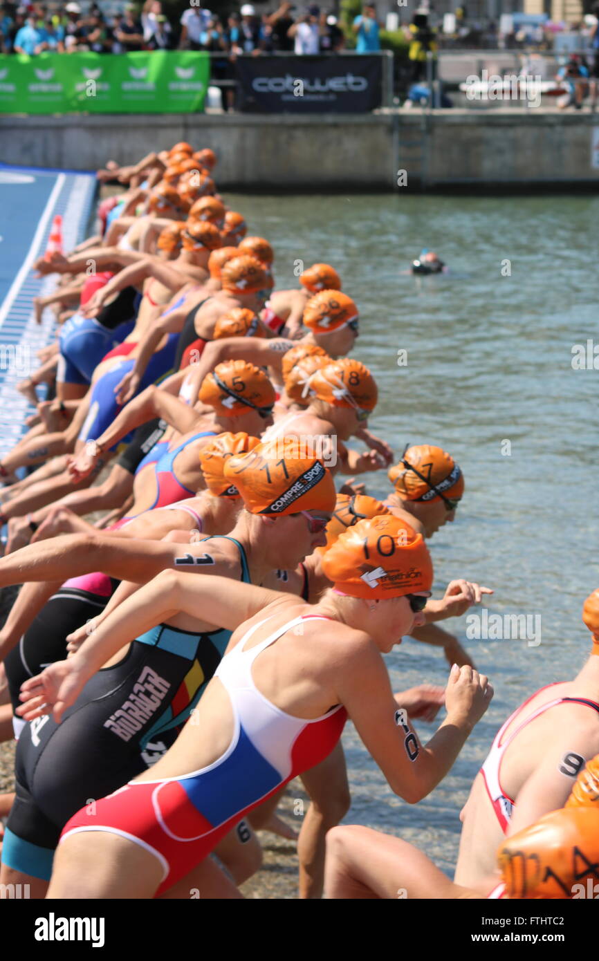 The swim start of a triathlon as female competitors prepare to enter