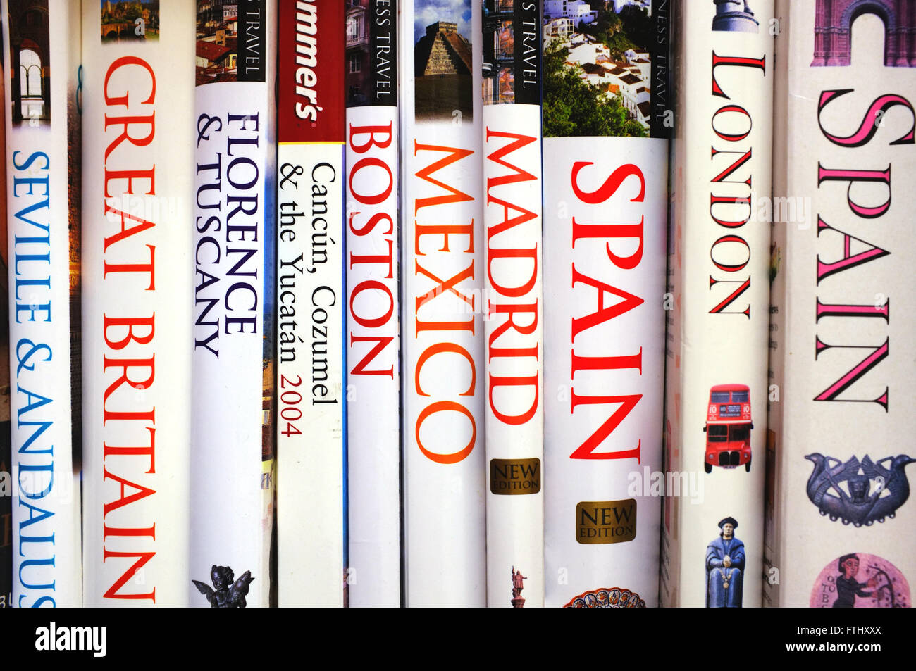 A stack of travel guide books for different countries and cities cross