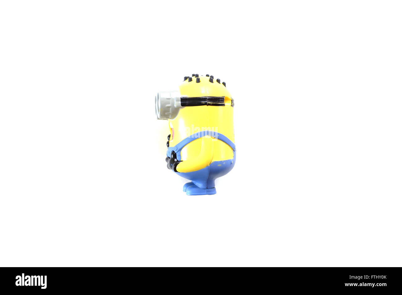 A side view of a toy figure from the Minions film photographed against a white background. Stock Photo