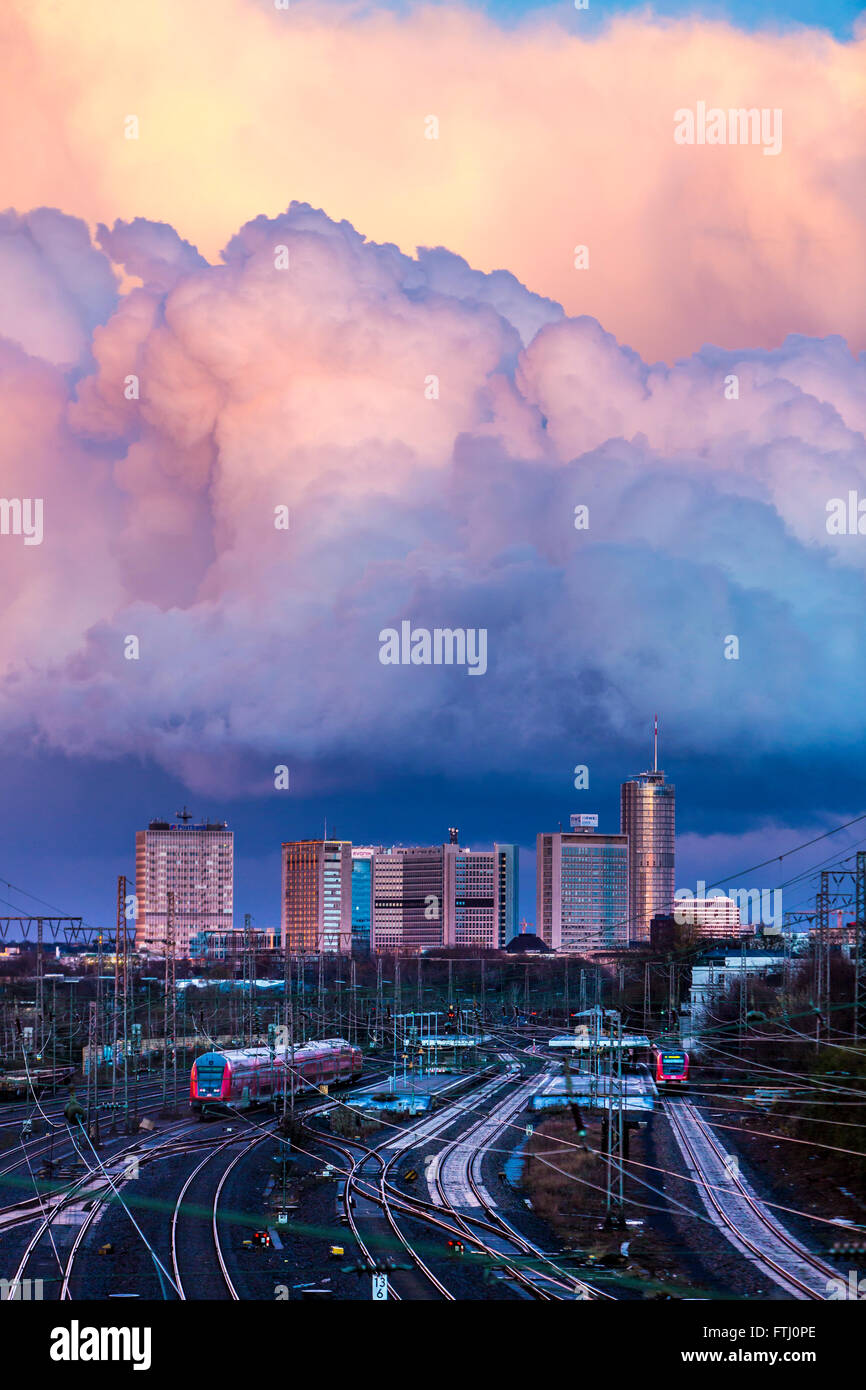 Skyline of the business district of Essen, Germany, railway tracks to the central station, storm clouds, trains, Stock Photo