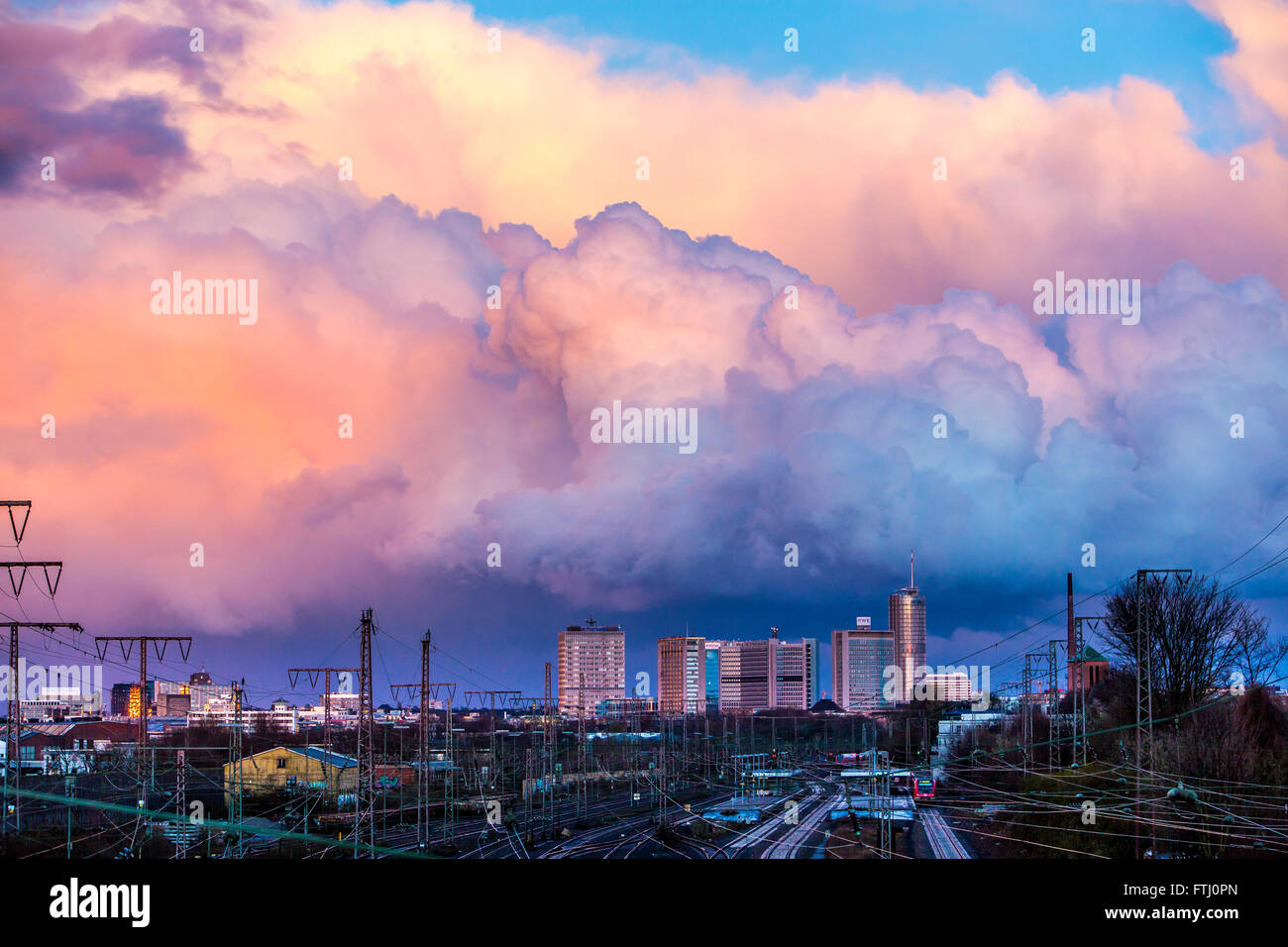 Skyline of the business district of Essen, Germany, railway tracks to the central station, storm clouds, trains, Stock Photo