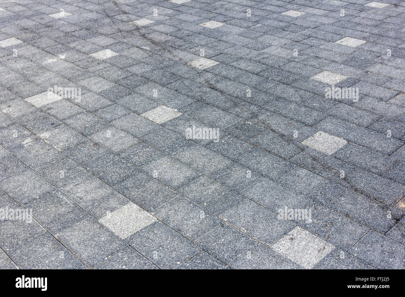Perspective View of Monotone Gray dirty Brick Stone Street Road. Sidewalk, Pavement Texture Background Stock Photo