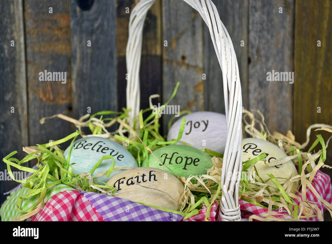 Inspirational message on Easter eggs in wicker basket with gingham fabric. Stock Photo