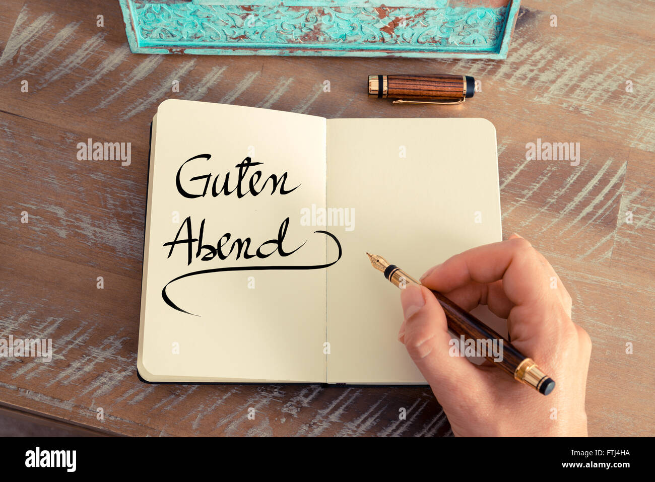 Handwritten text in German "Guten Abend" translation Good Evening