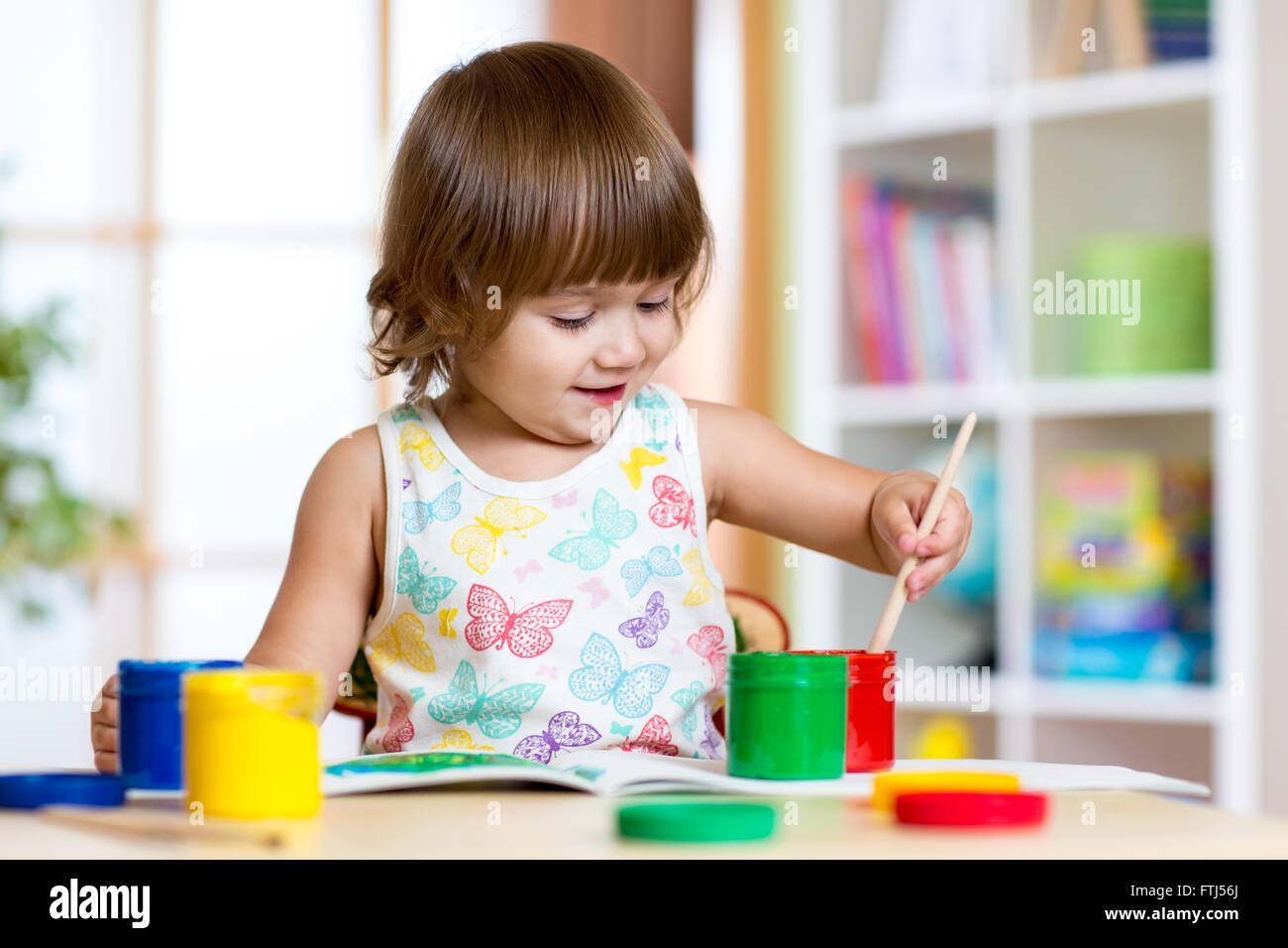 Child painting in kindergarten or playschool Stock Photo