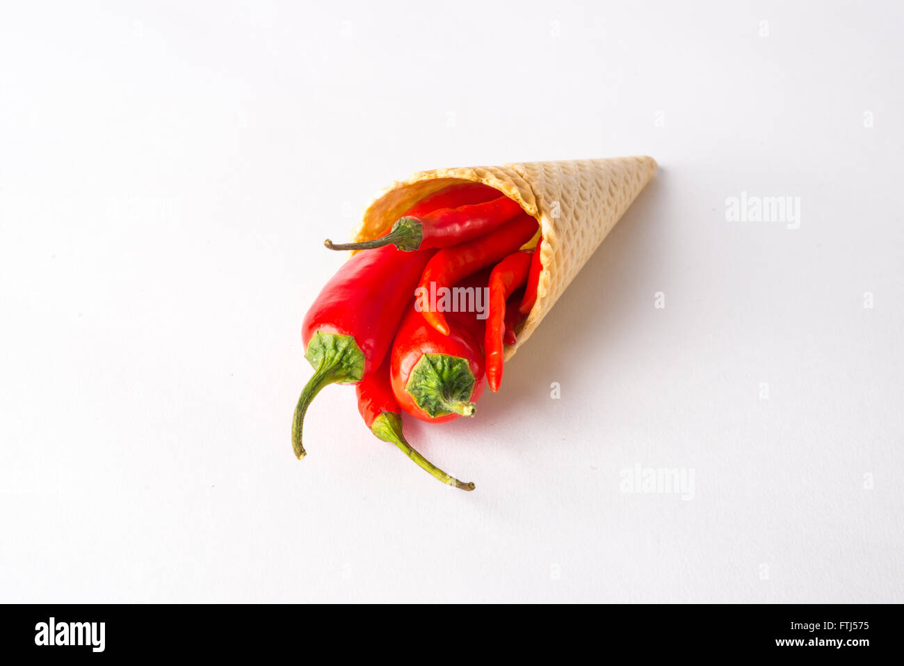 Red hot chili peppers in a wafer cone, unusual food Stock Photo