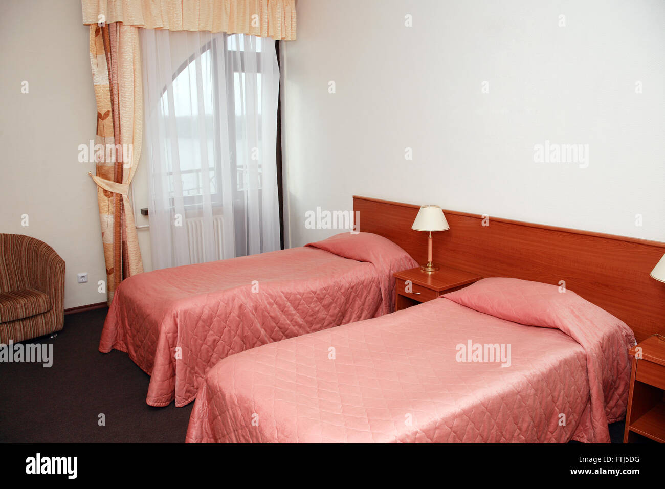 Home interior. Empty hotel room with two beds Stock Photo
