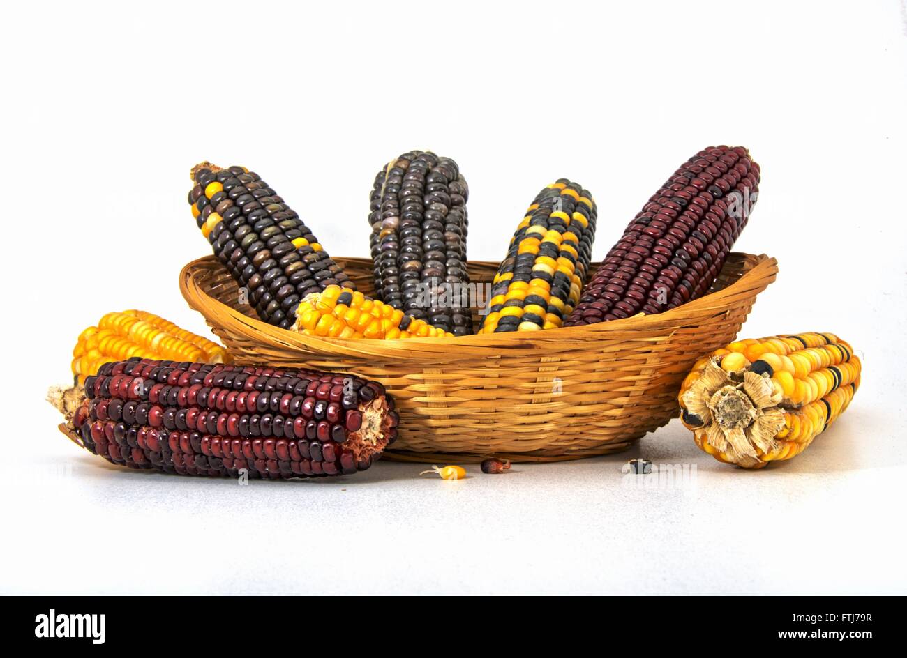 Basket isolated with different corn cobs Stock Photo