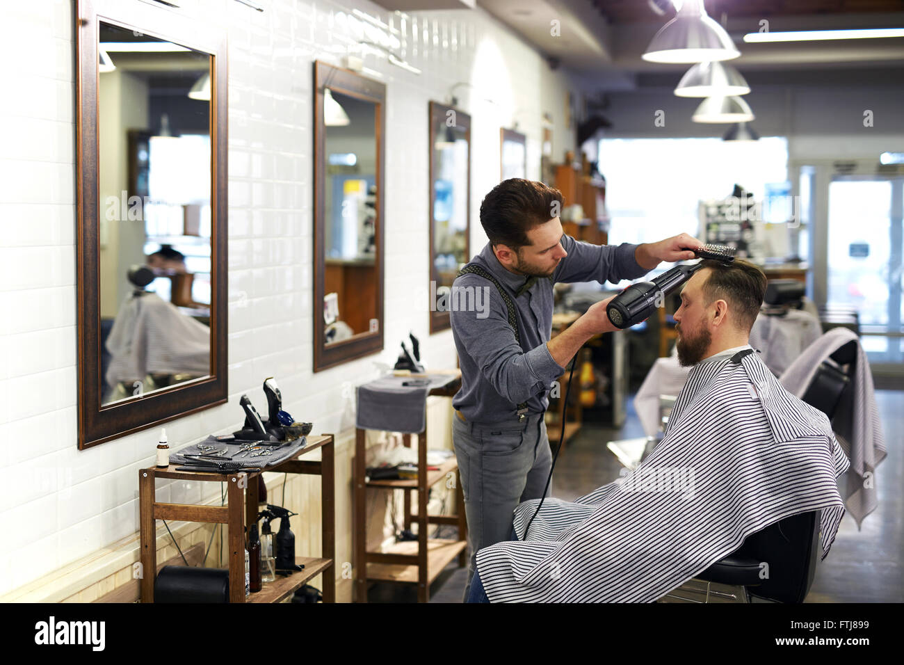 Barber drying client hair dryer hi-res stock photography and images - Alamy