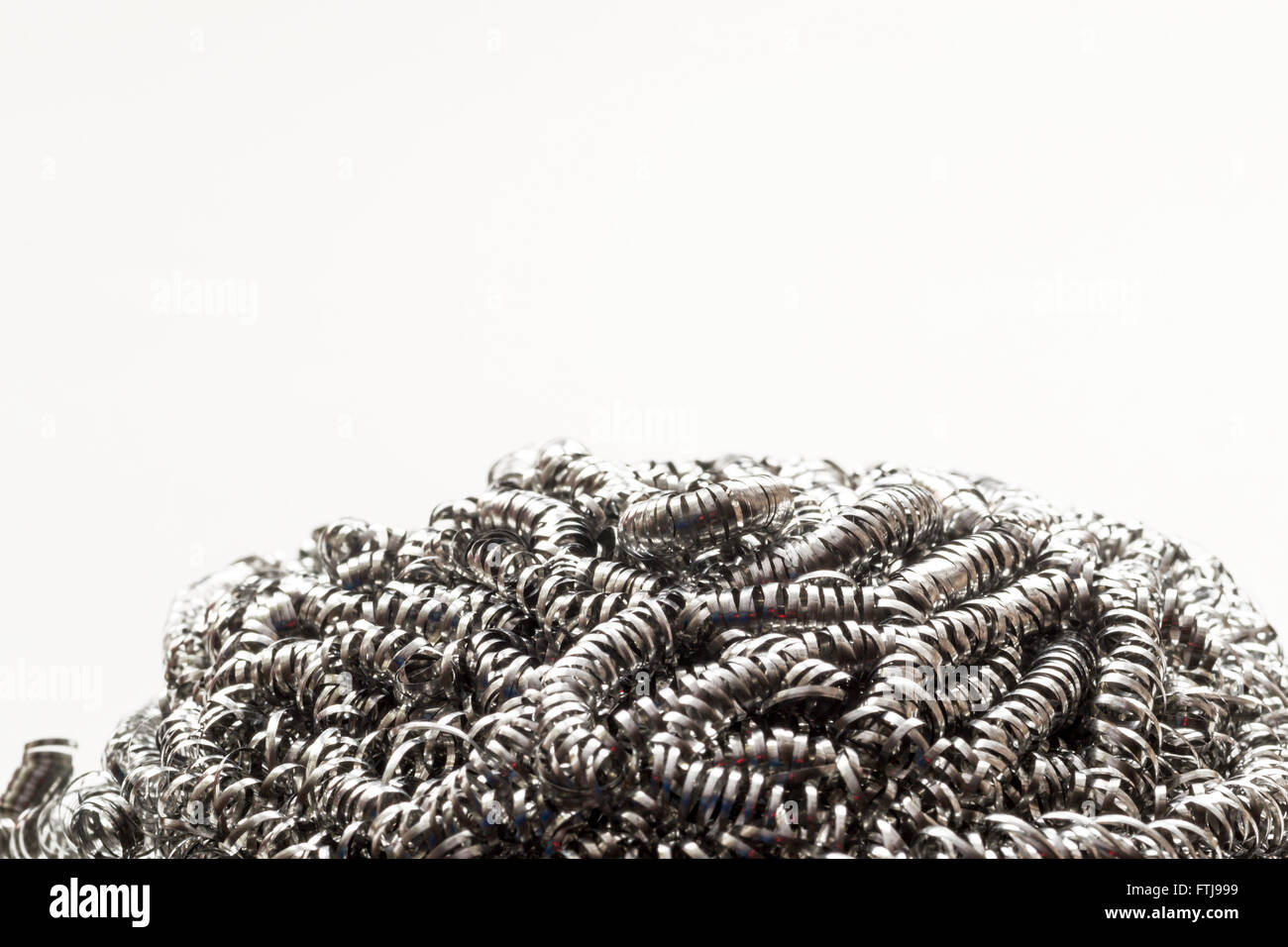 Closeup macro of a metal scrubbing cleaning brush. Repeating patterns of clean unused metallic strands with copy space area for Stock Photo