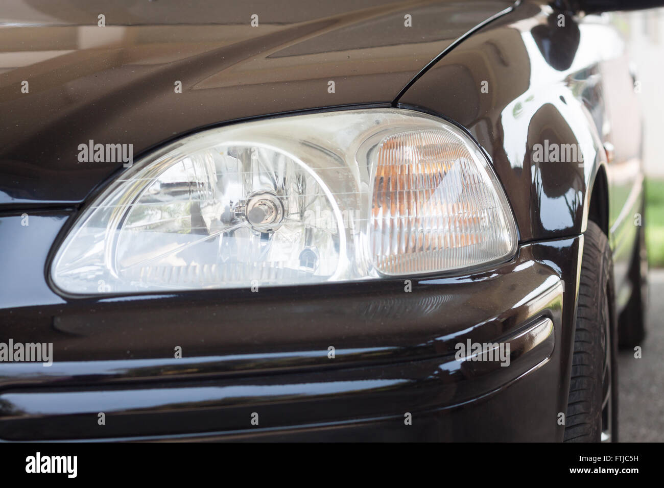 Closeup headlight of black coupe, stock photo Stock Photo