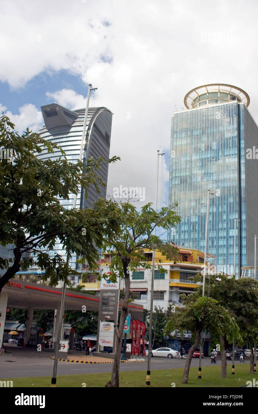 The new Vattanac Capital Tower (left) and Canadia Tower rise above a city street in the city center of Penh, Cambodia. Stock Photo